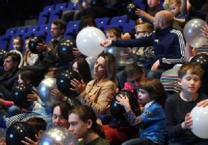 photo from the resonate event showing audience holding balloons
