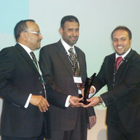 Photograph of Mohammad receiving the award