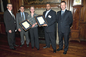 Harry and Joan receiving their awards from the Chairman of AUCSO and the Acting Vice Chancellor of City University